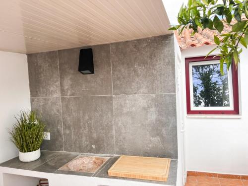 a bathroom with a shower with a stone wall at Casa Mel-Mina São Domingos-Praia fluvial-Terraço-3km-arcondicionado in Mértola