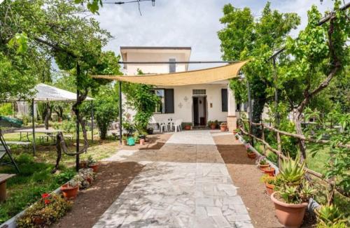 a house with a walkway in front of a yard at Etna, salvia e rosmarino in Maletto
