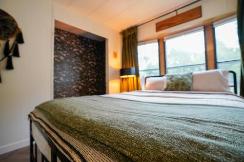 a bedroom with a large bed with a large window at Grandma's House at Rosewood Lodge in Iola