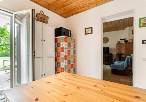 a kitchen with a wooden table in a room at Etna, salvia e rosmarino in Maletto