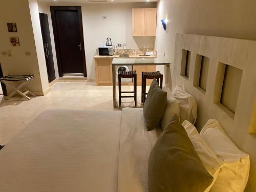 a large bed in a room with a kitchen at Cozy studio in Azzurra Resort Sahl Hasheesh 65 Sq M in Hurghada