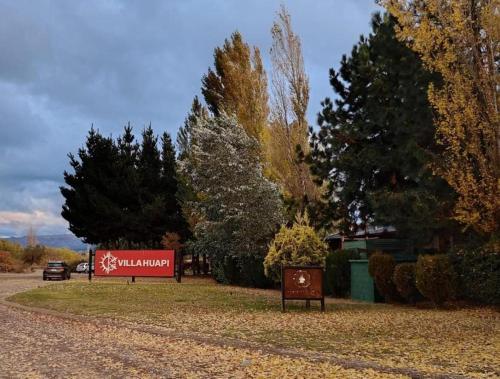 a sign on the side of a road with trees at Atardecer en la Estepa in Dina Huapi