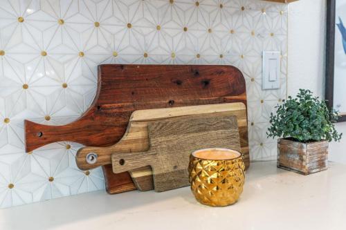 a wooden instrument on a table next to a vase at La Quinta Cove Oasis - Pool,Spa,Hiking,Tennis,Golf,Stagecoach and Coachella! in La Quinta
