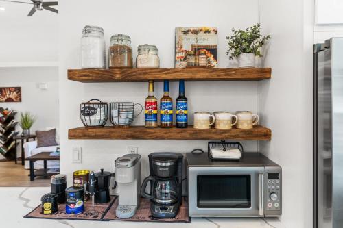 a kitchen with a microwave on a counter at La Quinta Cove Oasis - Pool,Spa,Hiking,Tennis,Golf,Stagecoach and Coachella! in La Quinta