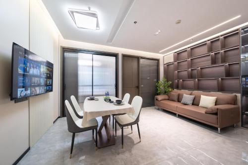 a living room with a table and a couch at Today Aparthotel West Lujiazui Shanghai in Shanghai
