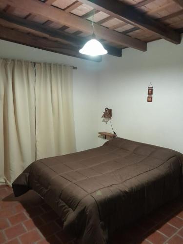 a bedroom with a large bed in a room at Cabañas Pedras Moras in Tanti