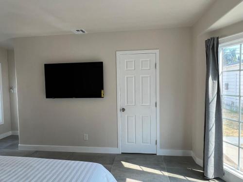 a bedroom with a flat screen tv on the wall at Fully Remodeled 2B1B Home in Baldwin3369 in Baldwin Park