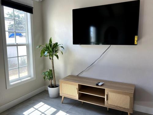 a living room with a flat screen tv on a wall at Fully Remodeled 2B1B Home in Baldwin3369 in Baldwin Park