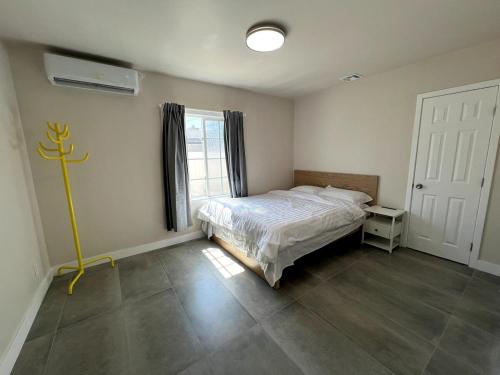 a bedroom with a bed and a window at Fully Remodeled 2B1B Home in Baldwin3369 in Baldwin Park