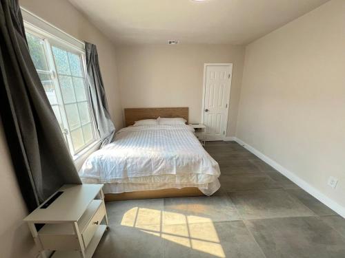 a bedroom with a bed and a window at Fully Remodeled 2B1B Home in Baldwin3369 in Baldwin Park