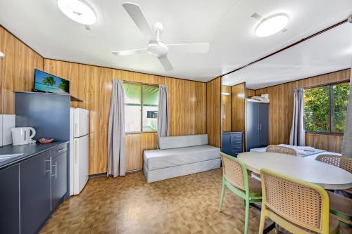 a kitchen and living room with a table and chairs at Mission Beach Hideaway Holiday Village in Mission Beach