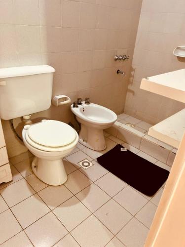 a bathroom with a toilet and a sink and a shower at Temporario del Sur in Santiago del Estero
