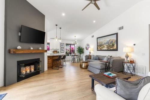 a living room with a couch and a fireplace at La Quinta Cove Oasis - Pool,Spa,Hiking,Tennis,Golf,Stagecoach and Coachella! in La Quinta