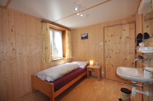 1 dormitorio con cama, lavabo y ventana en Gasthaus Waldheim, en Fürstenaubruck