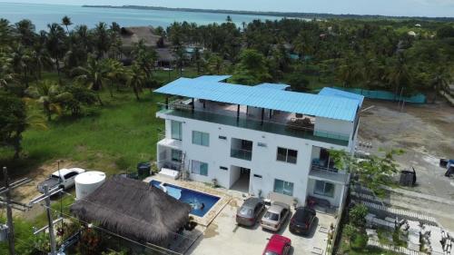 an aerial view of a white house with a blue roof at Baleares Apartamentos in Moñitos