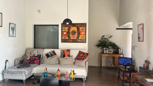 a living room with a couch and a table at Casa en corazón zona de bodegas in Perdriel