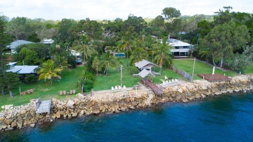 an aerial view of a house next to the water at Belles on Ballow - Lorikeet Lodge - Absolute Waterfront in Amity Point