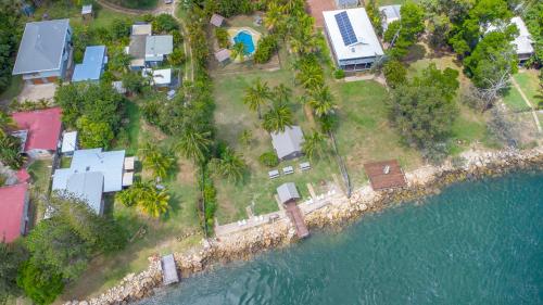 an aerial view of a house next to the water at Belles on Ballow - Lorikeet Lodge - Absolute Waterfront in Amity Point