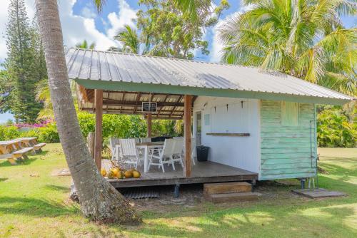 a house with a porch with a table and chairs at Belles on Ballow - Lorikeet Lodge - Absolute Waterfront in Amity Point