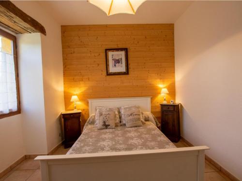 a bedroom with a bed with two night stands at Maison Périgourdine avec jardin clos et cheminée près de Lalinde - FR-1-616-159 in Lalinde