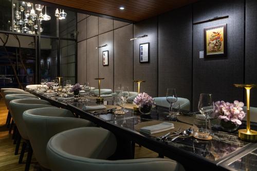a long dining room with a long table and chairs at AMANOR Hotel Chiang Mai in Chiang Mai