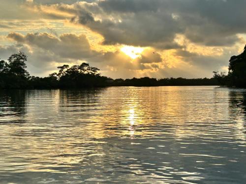 a view of a lake with the sun setting at Oceanfront Retreat in Casablanca in Same