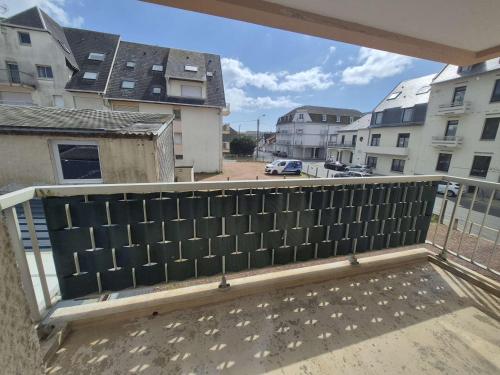 - un balcon avec une clôture au-dessus d'un bâtiment dans l'établissement Appartement proche plage avec parking et wifi - 4 personnes - FR-1-672-38, à Merlimont