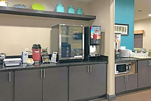 a kitchen with a counter top with a coffee maker at Comfort Inn & Suites O'Fallon - St Louis Area in O'Fallon