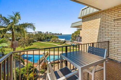 a balcony with a table and chairs and a view of the ocean at Kabi Apartment Caloundra - Self Contained in Golden Beach