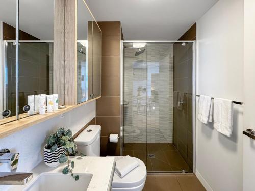 a bathroom with a shower and a toilet and a sink at Ocean View Modern 2 bedroom with Parking in St Kilda in Melbourne