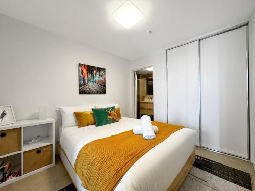 a bedroom with a large bed in a room at Ocean View Modern 2 bedroom with Parking in St Kilda in Melbourne