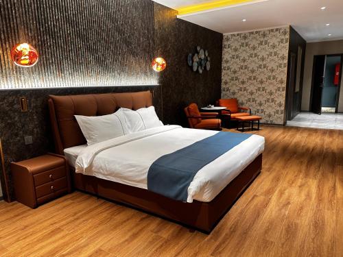 a bedroom with a large bed and a dining room at Bojon Hotel Ulaanbaatar - Soyolj Mall in Ulaanbaatar