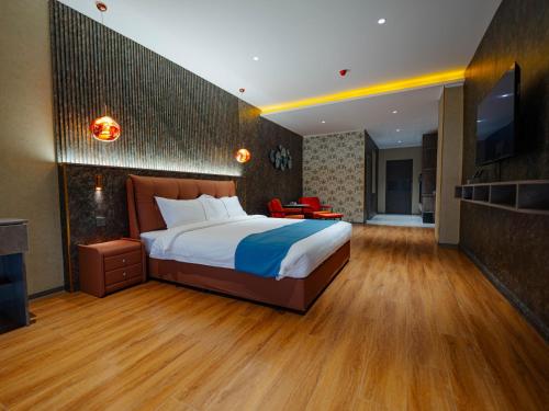 a hotel room with a bed and a television at Bojon Hotel Ulaanbaatar - Soyolj Mall in Ulaanbaatar