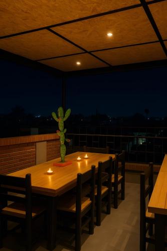 a wooden table with lights on top of a roof at Hotel Casa Acueducto - Lujo Cultural in Oaxaca City