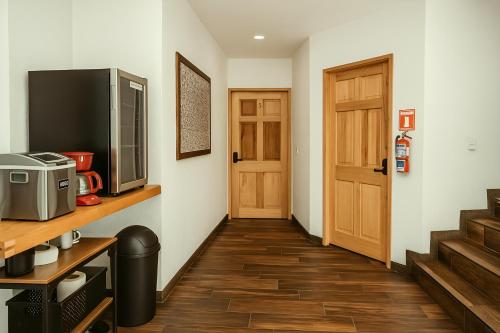 a room with a hallway with a television and a door at Hotel Casa Acueducto - Lujo Cultural in Oaxaca City