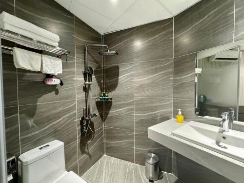 a bathroom with a toilet and a sink and a mirror at 22Land Moon West Lake in Hanoi