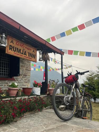 a bike parked in front of a rumaniana inn at Rumja Inn in Ghāchak