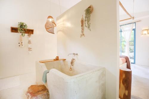 a bathroom with a bathtub in the corner of a room at Casa Kasoy - Private pool villa in El Nido