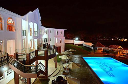a large house with a swimming pool at night at Greenpark Sundowner in Athi River