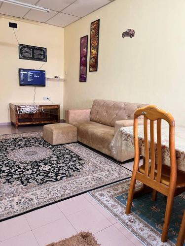 a living room with a couch and a chair at Hijau Homestay in Batu Gajah