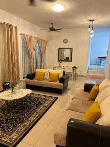 a living room with two couches and a table at Mstaycation in Kampong Ayer Panas