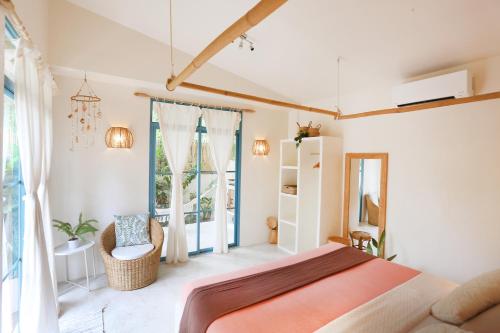 a bedroom with a bed and a large window at Casa Kasoy - Private pool villa in El Nido