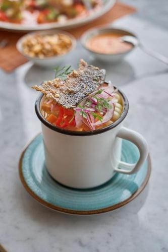 a cup of food on a plate on a table at Casa Andina Standard Ayacucho in Ayacucho