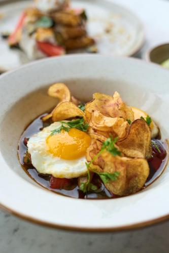 a bowl of food with an egg on top at Casa Andina Standard Ayacucho in Ayacucho