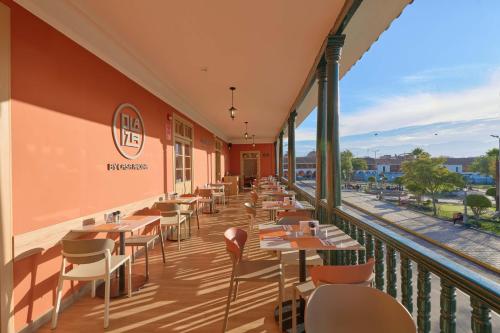 a restaurant with tables and chairs on a balcony at Casa Andina Standard Ayacucho in Ayacucho