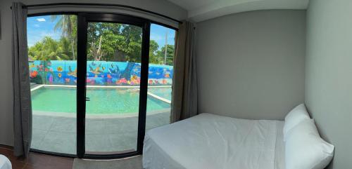 a bedroom with a sliding glass door with a swimming pool at Container house in La Esmeralda