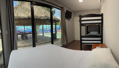 a bedroom with a bed and a view of a pool at Container house in La Esmeralda