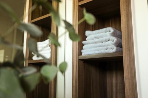 a stack of towels on a shelf in a bathroom at Wilderluxe Lake Keepit in Keepit