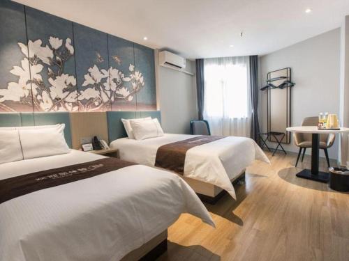 a hotel room with two beds and a table at Magnotel Business Shanghai New International Exhibition Center in Shanghai