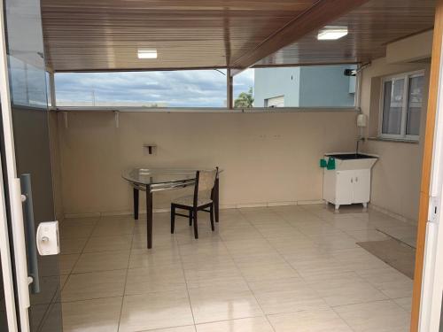 カシアス・ド・スルにあるApartamento Dois quartos e duas vagas garagem fechadasのテーブルと椅子のある空の部屋